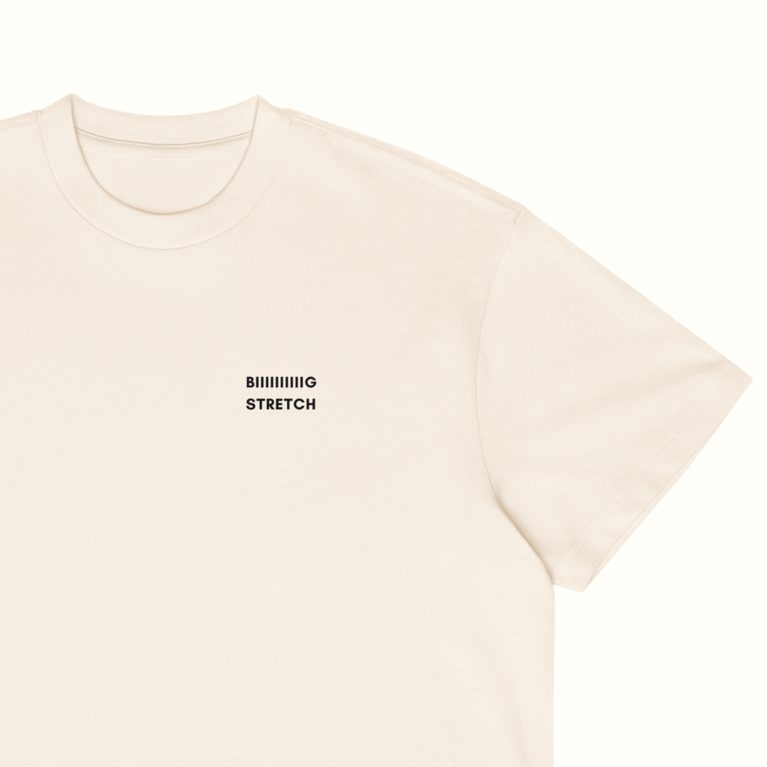 A close-up of a cream-colored short-sleeve t-shirt with the text &