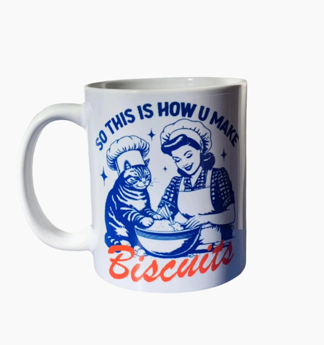 Mug with a woman and cat in a chefs hat. Text reads "so this is you you make biscuits". 