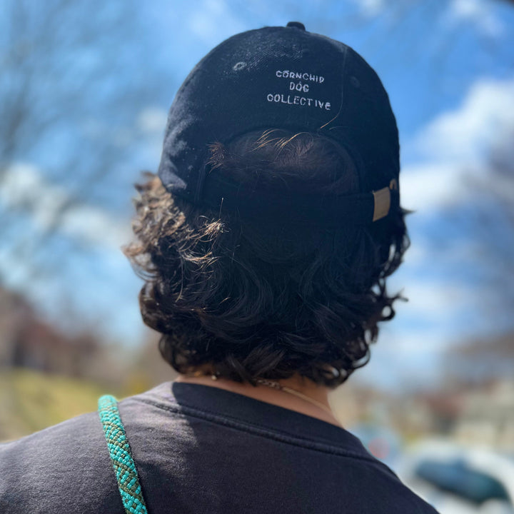 The back of a man wearing a baseball cap